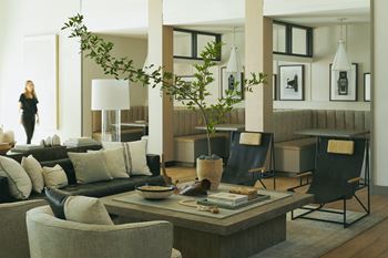 a living room with couches and chairs and a table